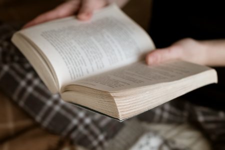 Open book in woman hands